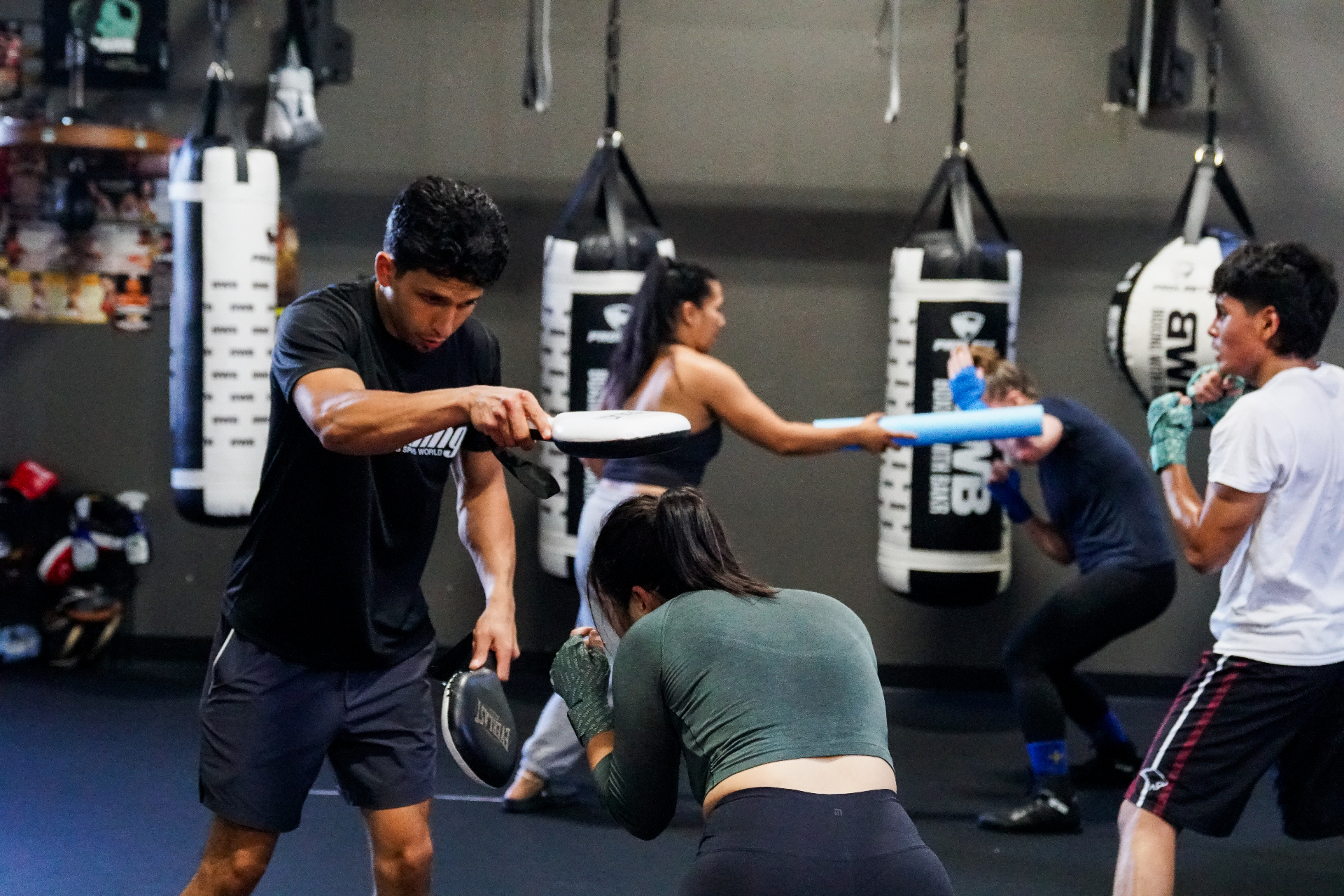 Coach Bakr holding mitts during a group class at Boxing With Bakr